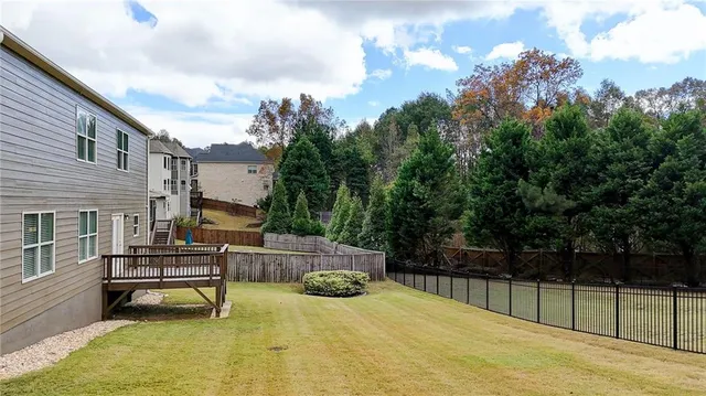 an aerial view of a house with swimming pool and seating area