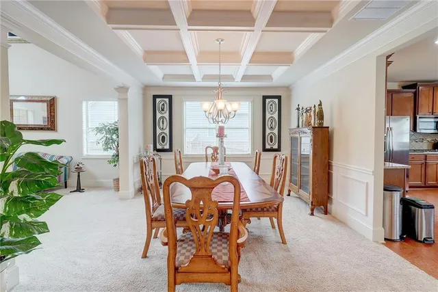 a room with stainless steel appliances kitchen island granite countertop a dining table chairs and view living room