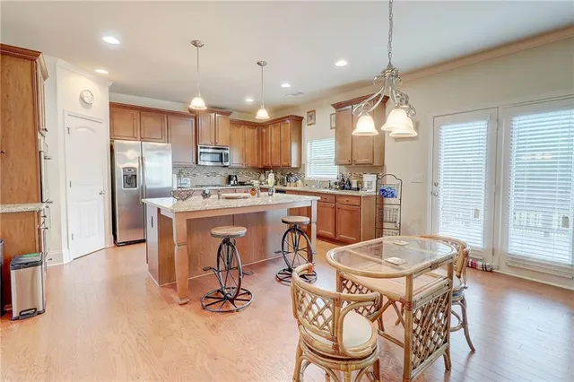 a large kitchen with a table and chairs