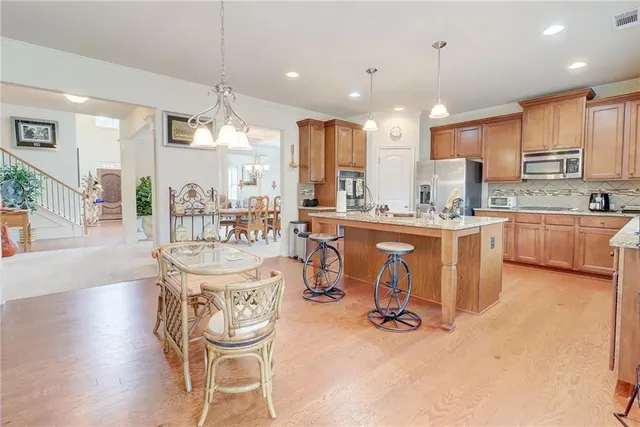 a kitchen with a sink refrigerator and cabinets