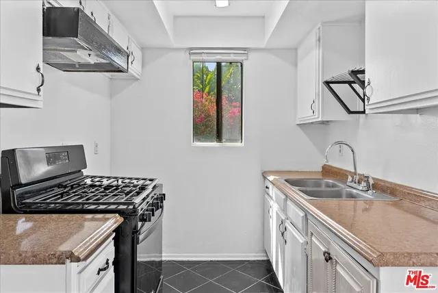 a kitchen with stainless steel appliances granite countertop a stove and a sink