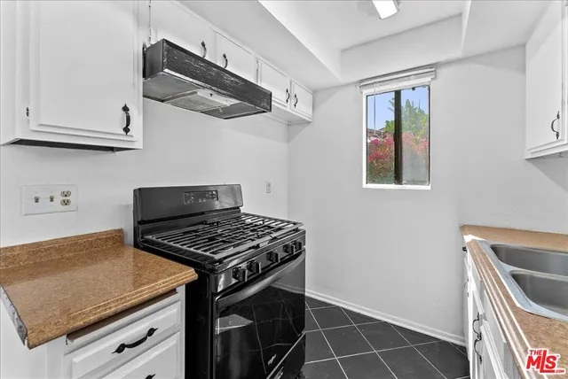 a kitchen with sink and cabinets