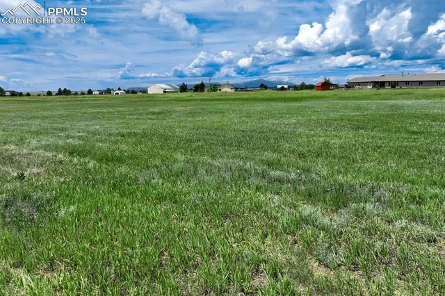 a view of a big yard with lots of green space and mountain view