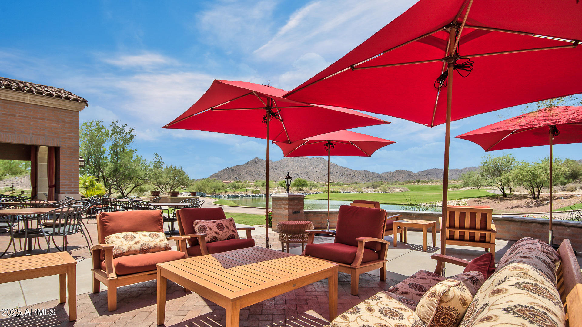 21287 North Black Rock Road, Unit 96 Buckeye, AZ 85396 - Photo 33 of 53 a view of a patio with a table and chairs under an umbrella