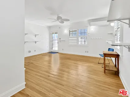 a view of kitchen and hall with wooden floor