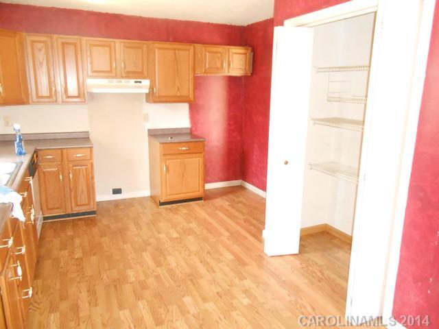 7441 Tuckaseegee Road Kannapolis, NC 28081 - Photo 6 of 14 a view of a kitchen with wooden floor and a refrigerator