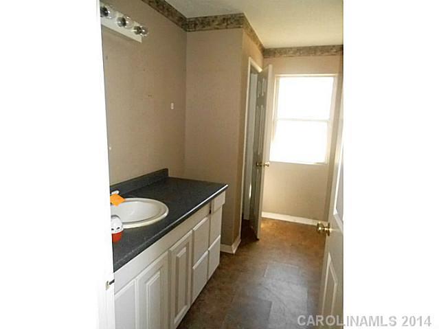 7441 Tuckaseegee Road Kannapolis, NC 28081 - Photo 10 of 14 a bathroom with a sink and a mirror