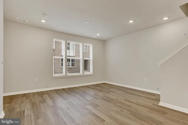 a kitchen with granite countertop a refrigerator stove top oven and sink