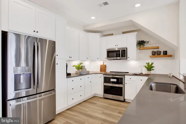 a bathroom with a sink a mirror and shower