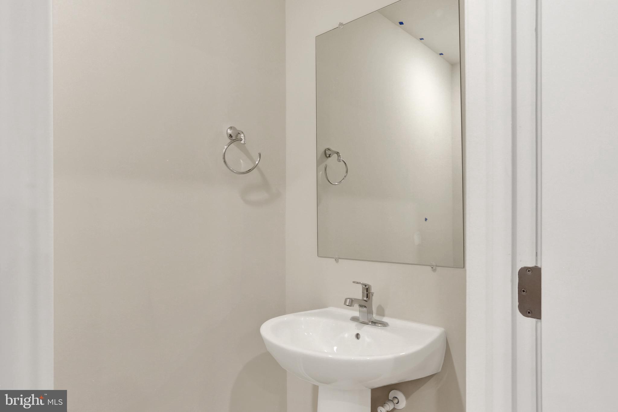9664 Swallowtail Lane Manassas, VA 20110 - Photo 24 of 95 a bathroom with a sink a mirror and shower