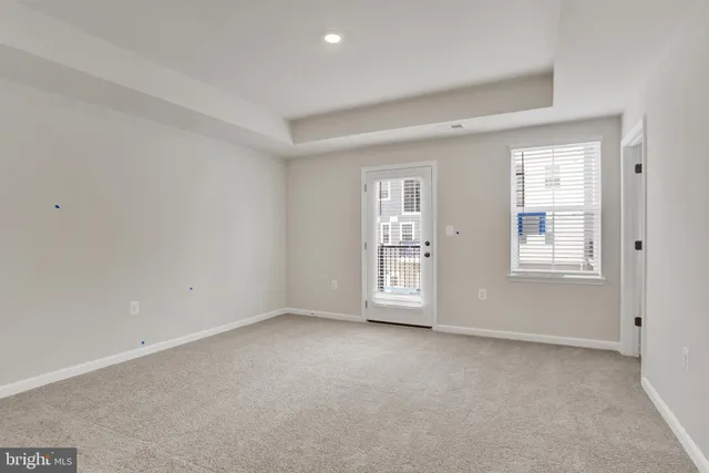 a bedroom with a bed a couch and a window