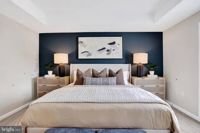 a bedroom with a bed and a wall painting