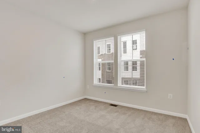 a view of a cafe with a table and chairs under an umbrella