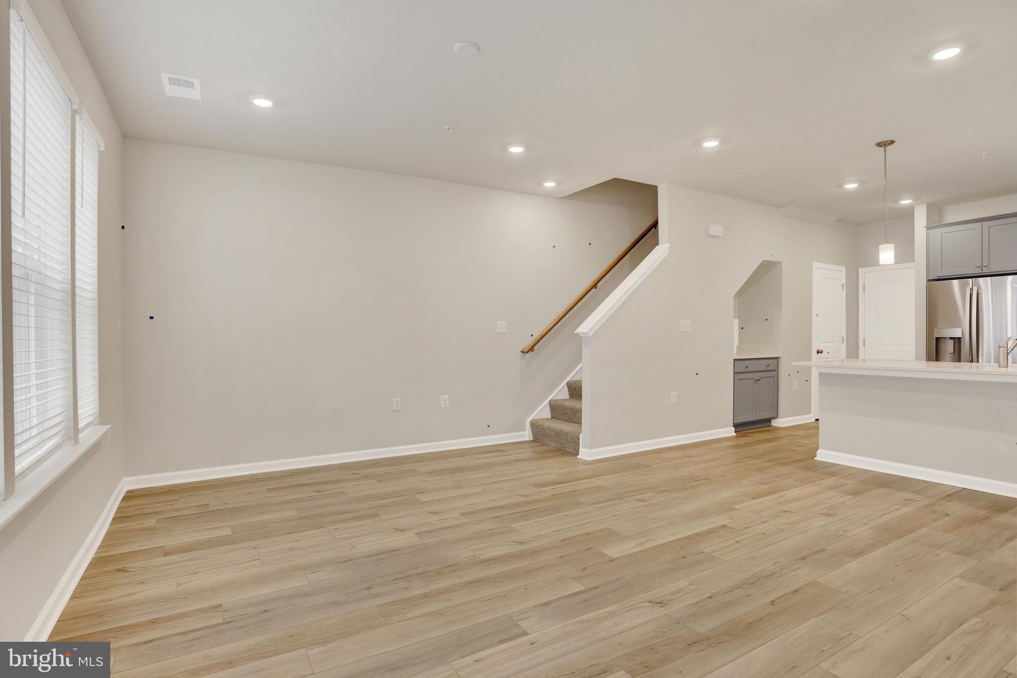 9664 Swallowtail Lane Manassas, VA 20110 - Photo 6 of 95 a view of an empty room with wooden floor and a window
