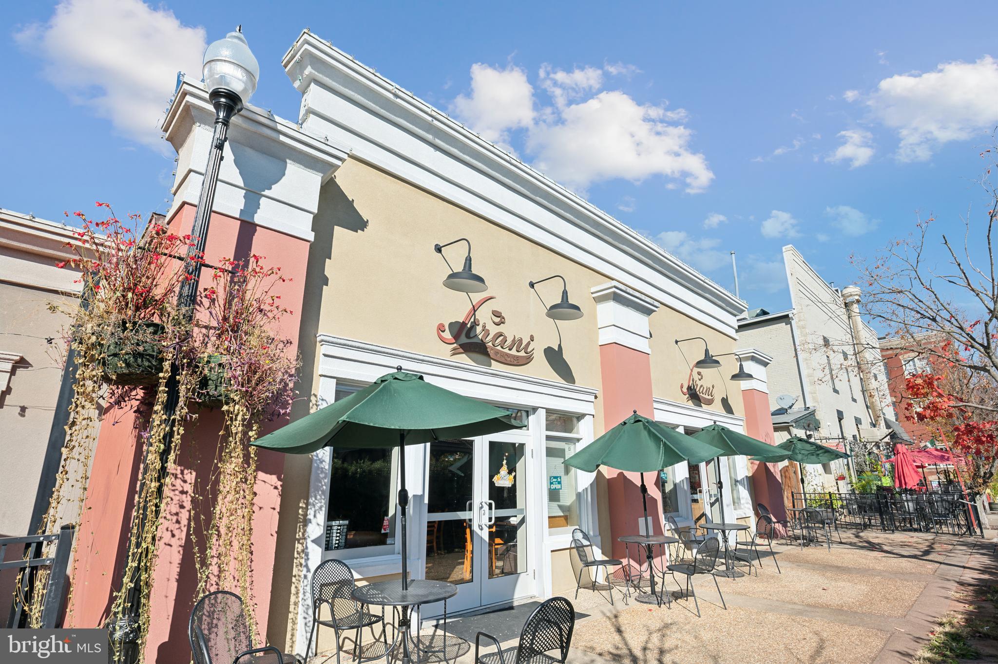 9664 Swallowtail Lane Manassas, VA 20110 - Photo 74 of 95 a view of a cafe with a table and chairs under an umbrella