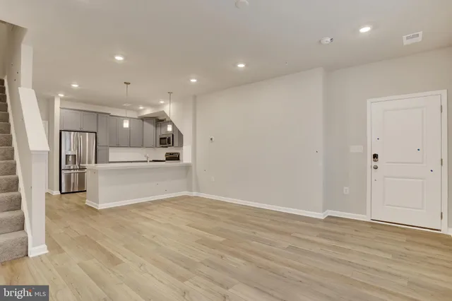 a living room with furniture potted plant and a window