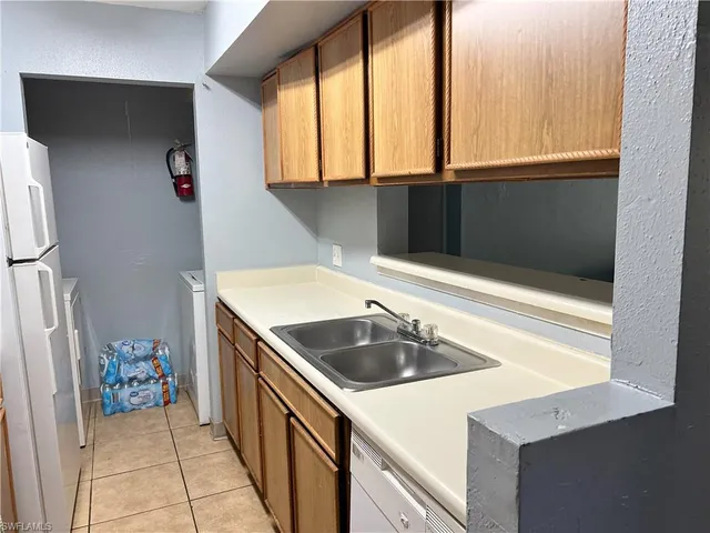 a kitchen with a sink a stove and cabinets