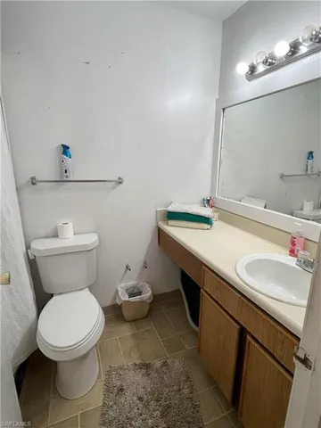 a bathroom with a sink mirror vanity and toilet