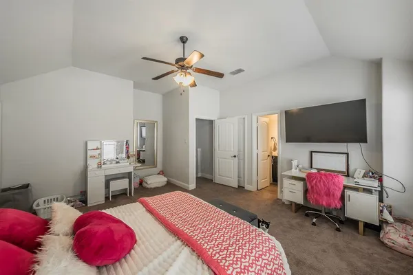 a bedroom with a bed and a chair