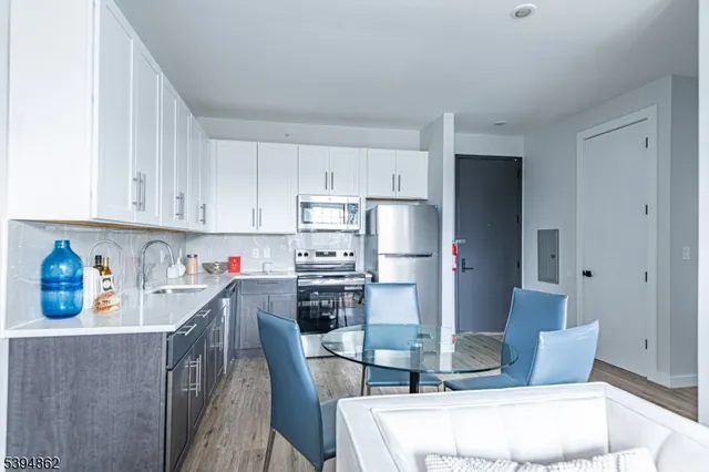 a kitchen with stainless steel appliances a refrigerator and cabinets