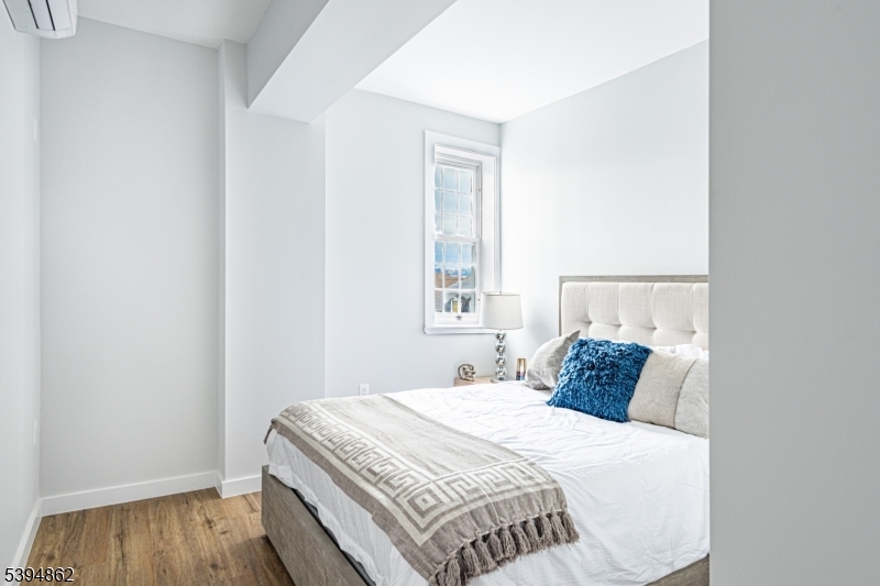 75 South Main Street, Unit 405 Phillipsburg, NJ 08865 - Photo 15 of 22 a bedroom with a bed and wooden floor