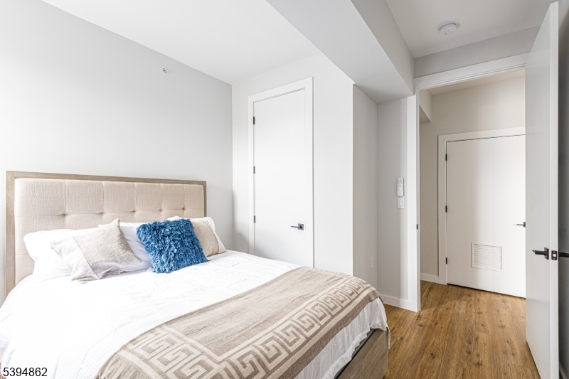 75 South Main Street, Unit 405 Phillipsburg, NJ 08865 - Photo 16 of 22 a bedroom with a bed and wooden floor