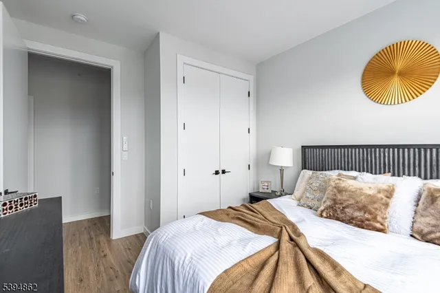 a bedroom with a bed and painting on the wall