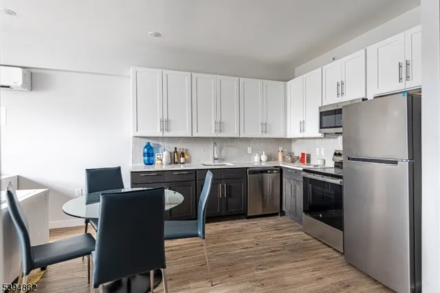 a kitchen with stainless steel appliances granite countertop a refrigerator sink and cabinets
