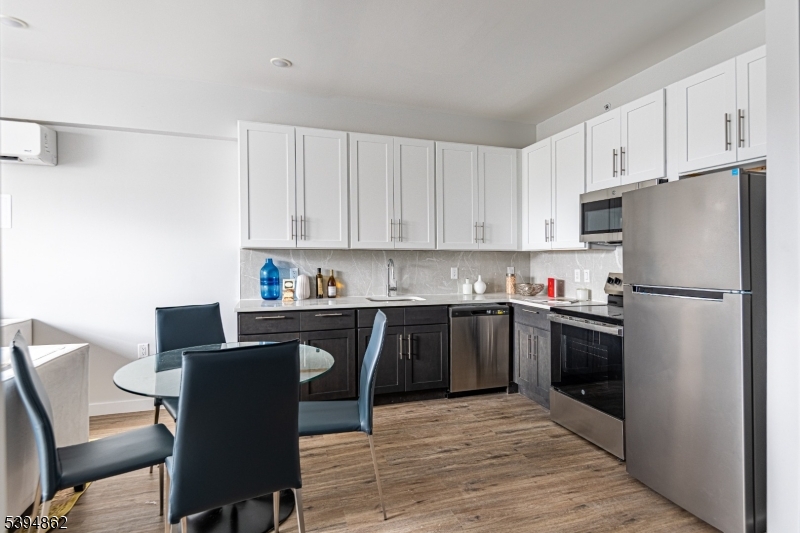 75 South Main Street, Unit 405 Phillipsburg, NJ 08865 - Photo 9 of 22 a kitchen with stainless steel appliances granite countertop a refrigerator sink and cabinets