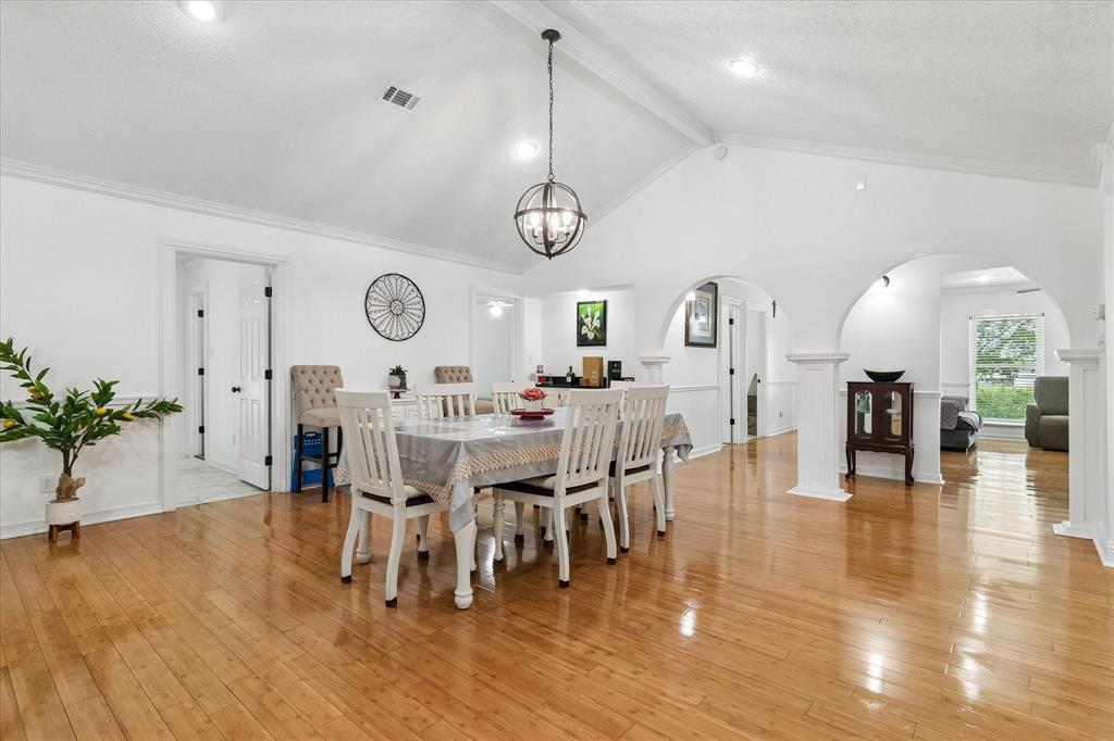 3007 McReynolds Road Sanger, TX 76266 - Photo 3 of 39 Vaulted ceiling dining area with wood-finish flooring, featuring a spherical chandelier and arched doorways