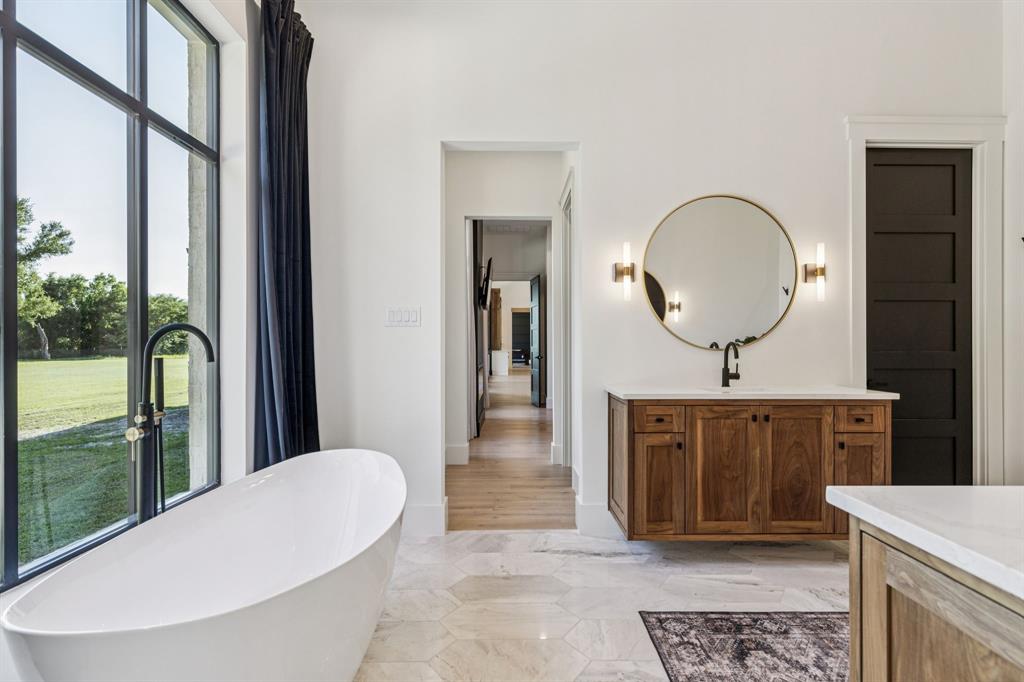 1890 McConnell Road Gunter, TX 75058 - Photo 19 of 40 a view of a hallway view with a mirror and a sink