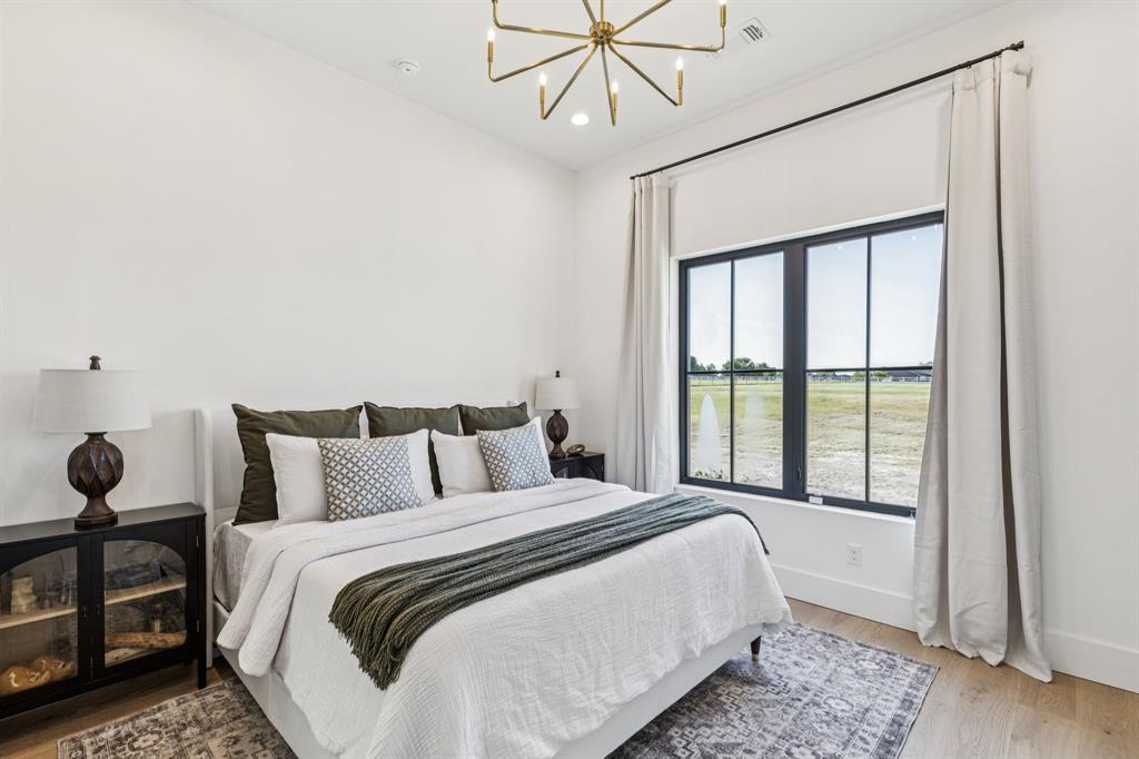 1890 McConnell Road Gunter, TX 75058 - Photo 20 of 40 a bedroom with a large bed and a window