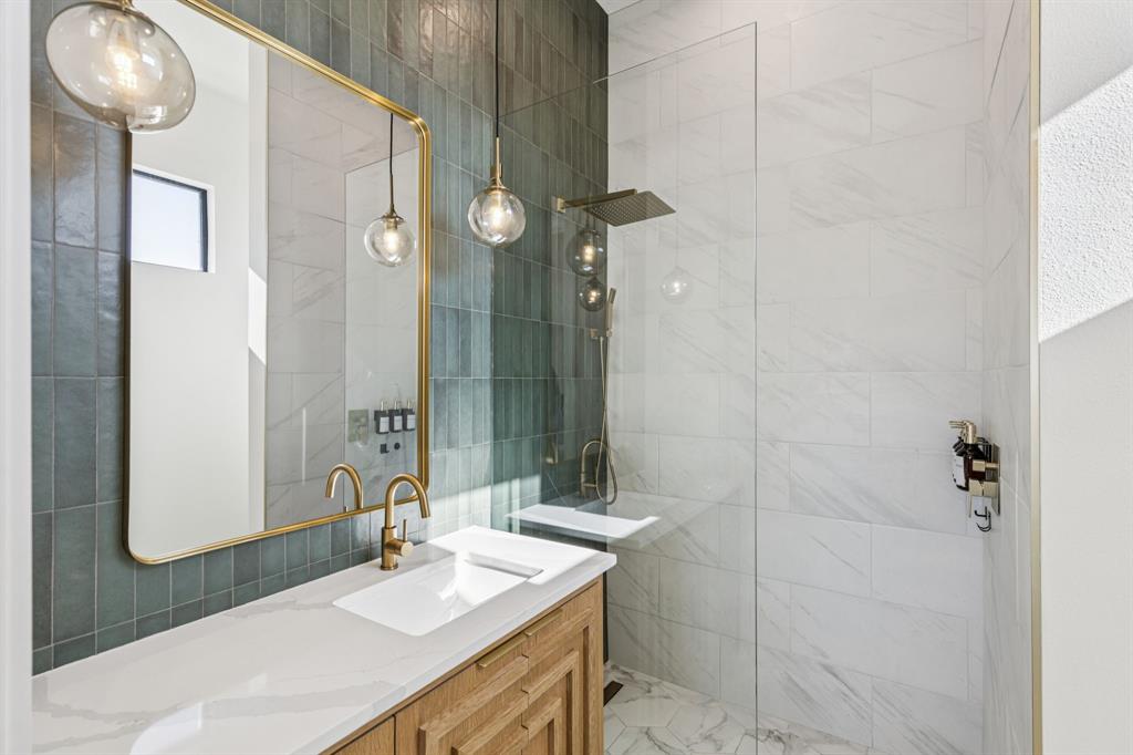 1890 McConnell Road Gunter, TX 75058 - Photo 21 of 40 a bathroom with a sink vanity granite shower and a mirror