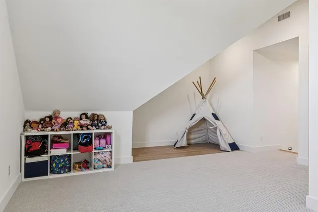 a view of a garage with rack and white walls