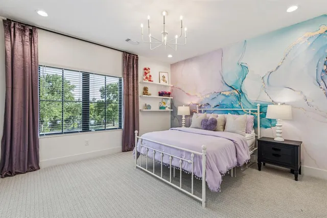 a bedroom with a bed table and window