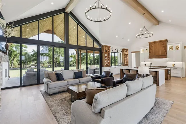 a living room with furniture and large windows