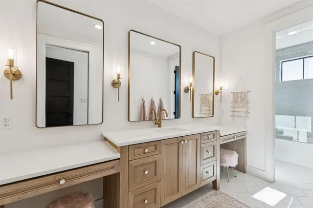 a spacious bathroom with a granite countertop sink and a mirror