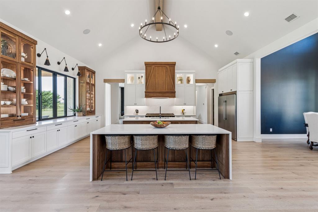 1890 McConnell Road Gunter, TX 75058 - Photo 7 of 40 a dining room with stainless steel appliances a table and chairs