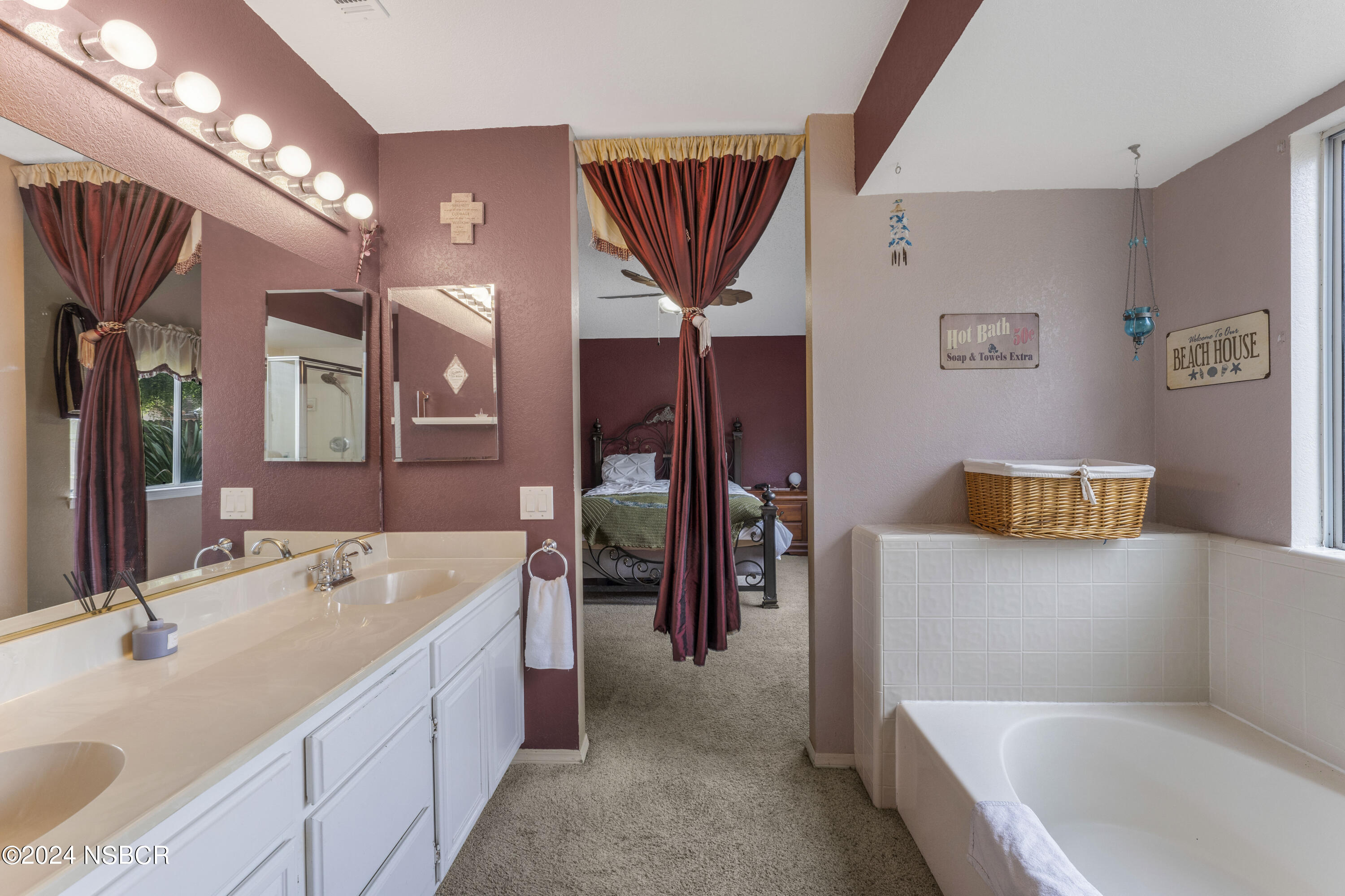 816 Cooper Drive Lompoc, CA 93436 - Photo 17 of 35 a en suite bathroom with a bathtub sink and mirror