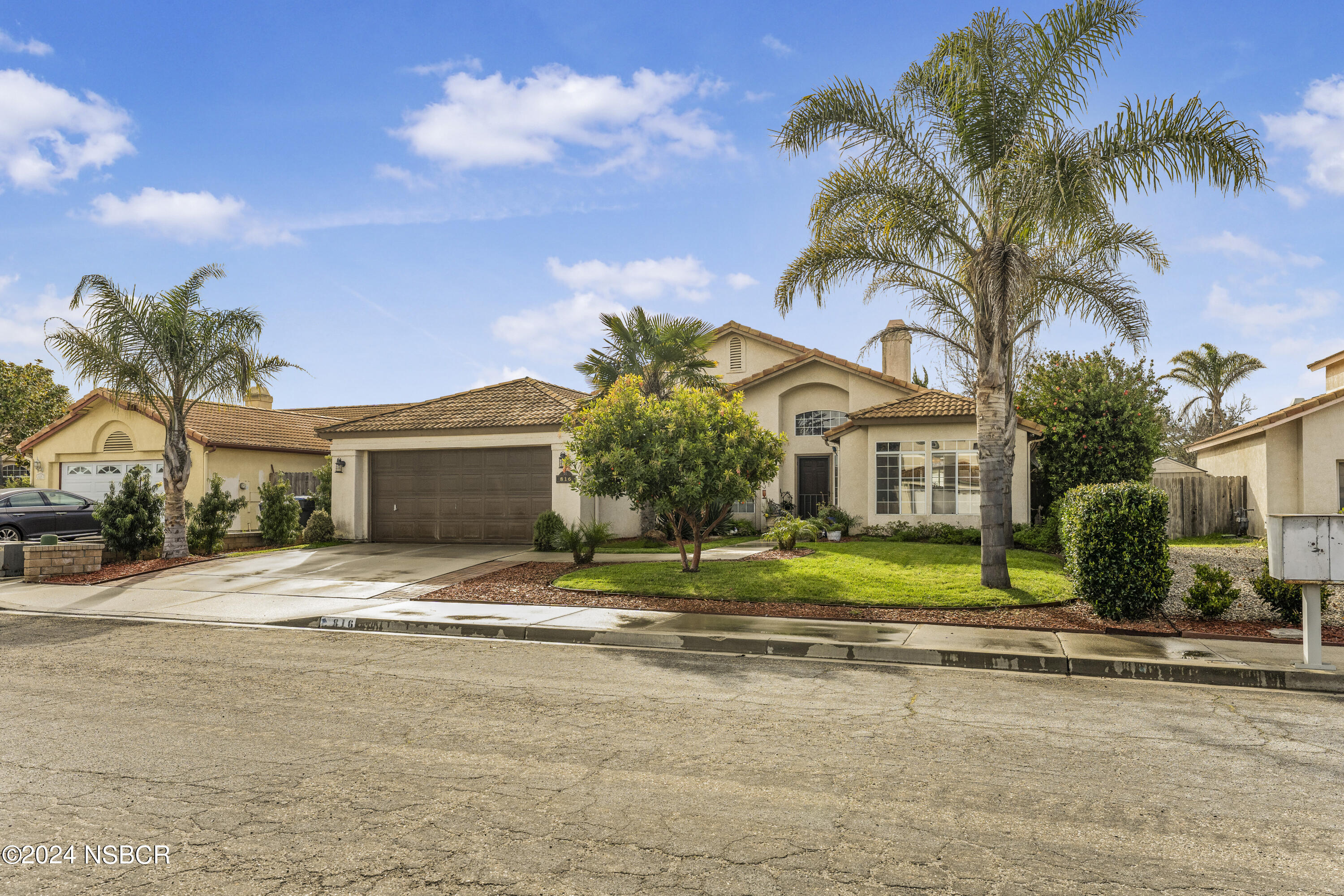 816 Cooper Drive Lompoc, CA 93436 - Photo 2 of 35 a yellow house with palm trees in front of it