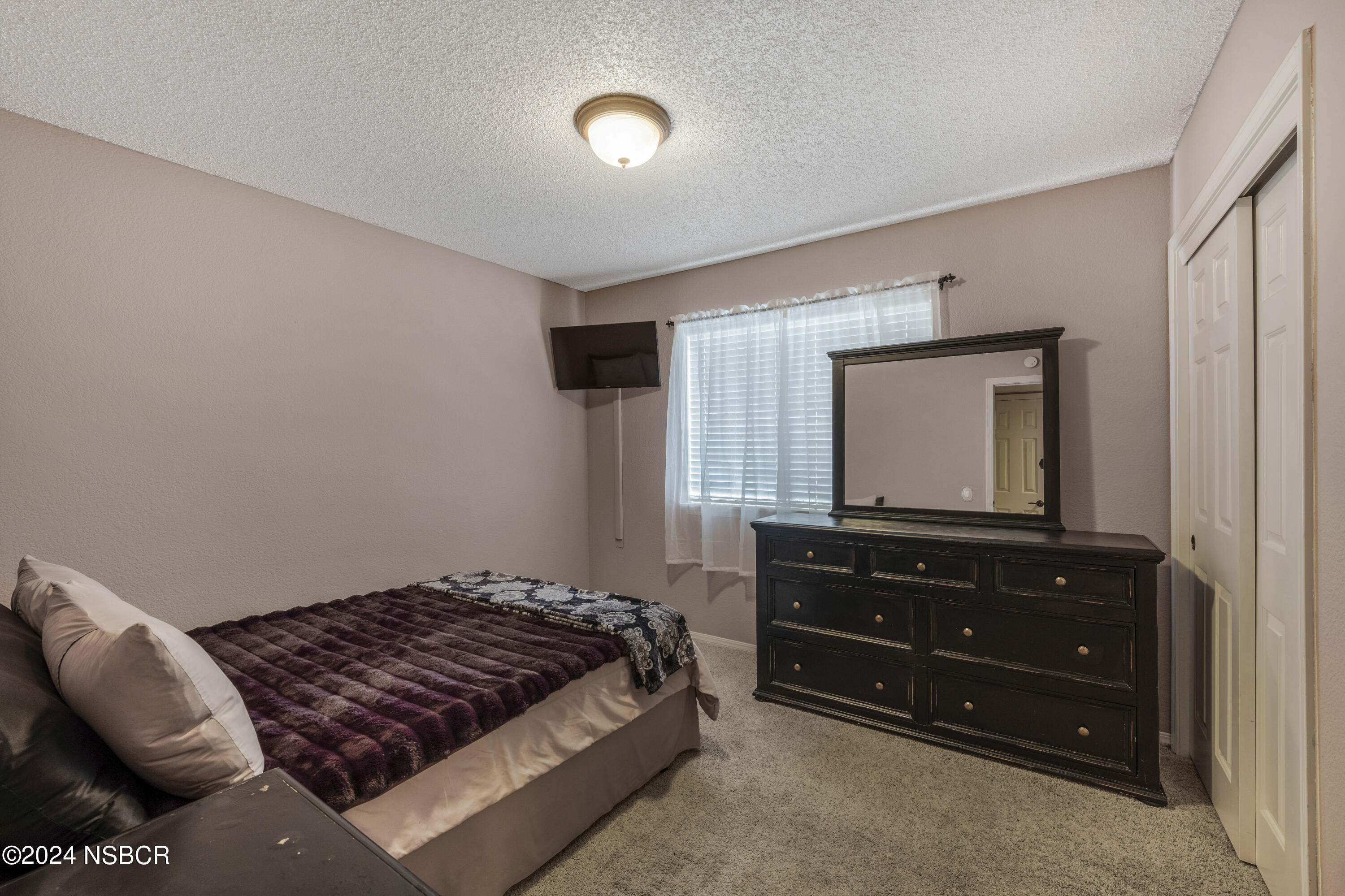 816 Cooper Drive Lompoc, CA 93436 - Photo 21 of 35 a bedroom with a bed and a television