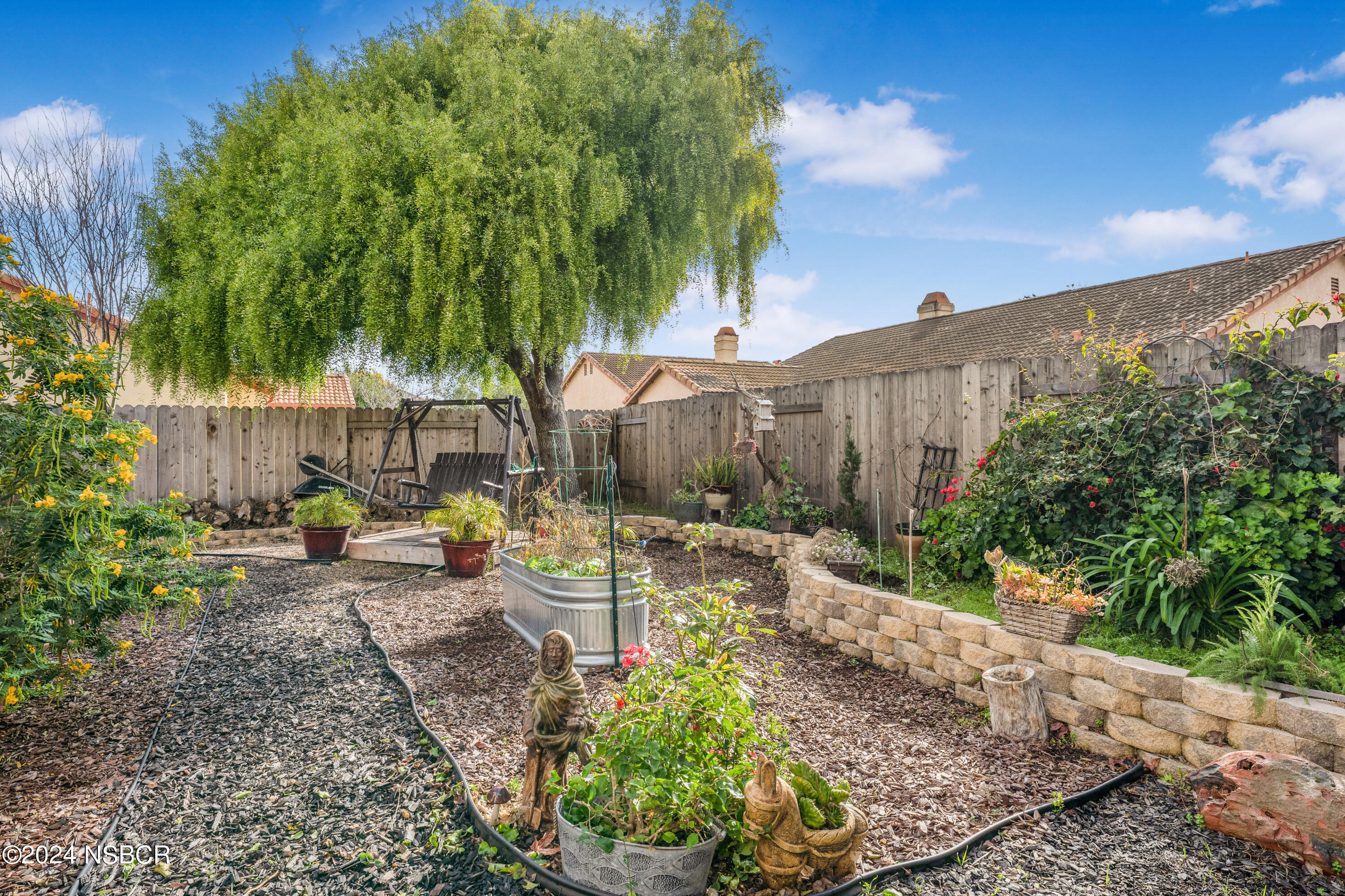 816 Cooper Drive Lompoc, CA 93436 - Photo 30 of 35 a backyard of a house with table and chairs