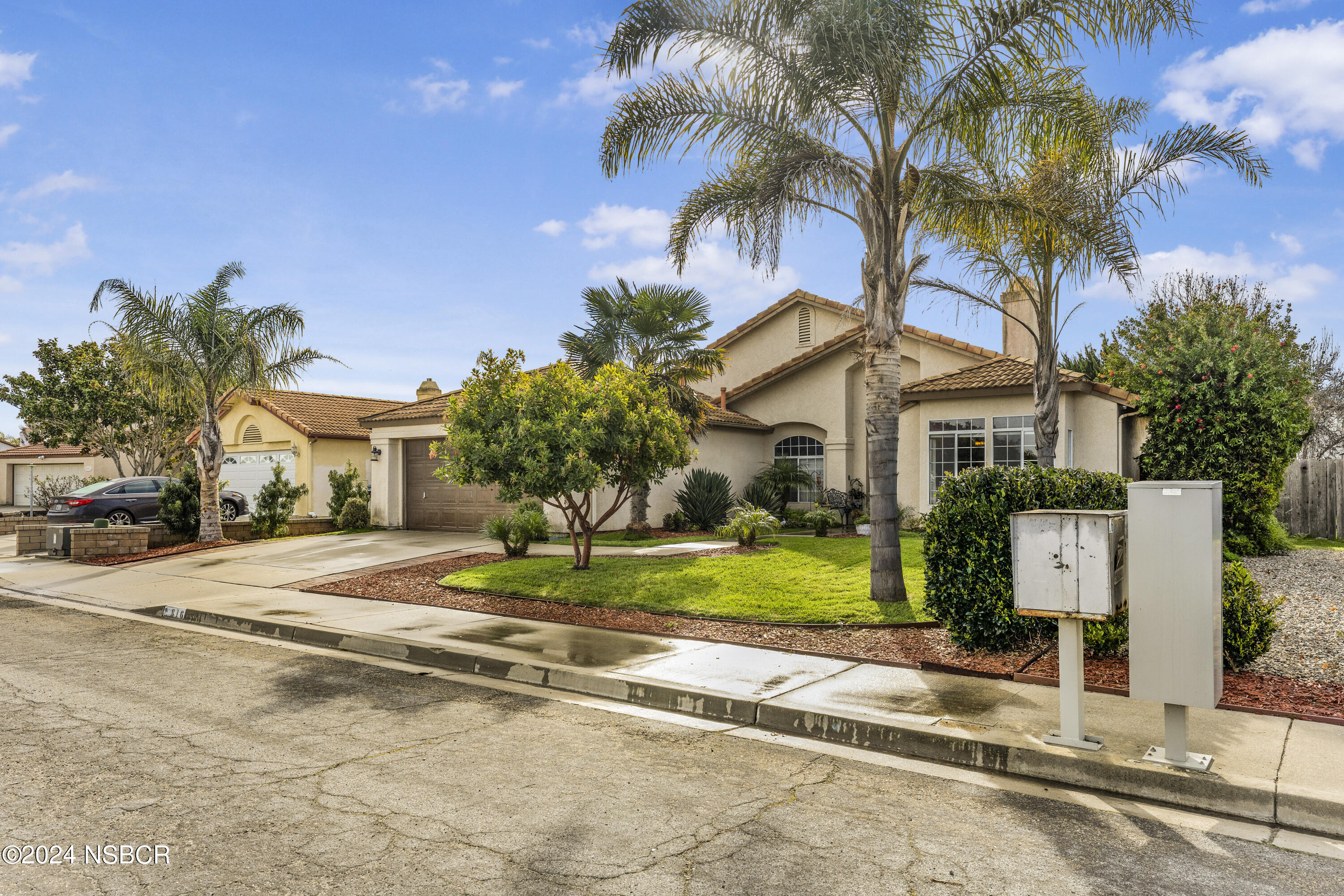 816 Cooper Drive Lompoc, CA 93436 - Photo 3 of 35 a front view of a house with a yard and garage