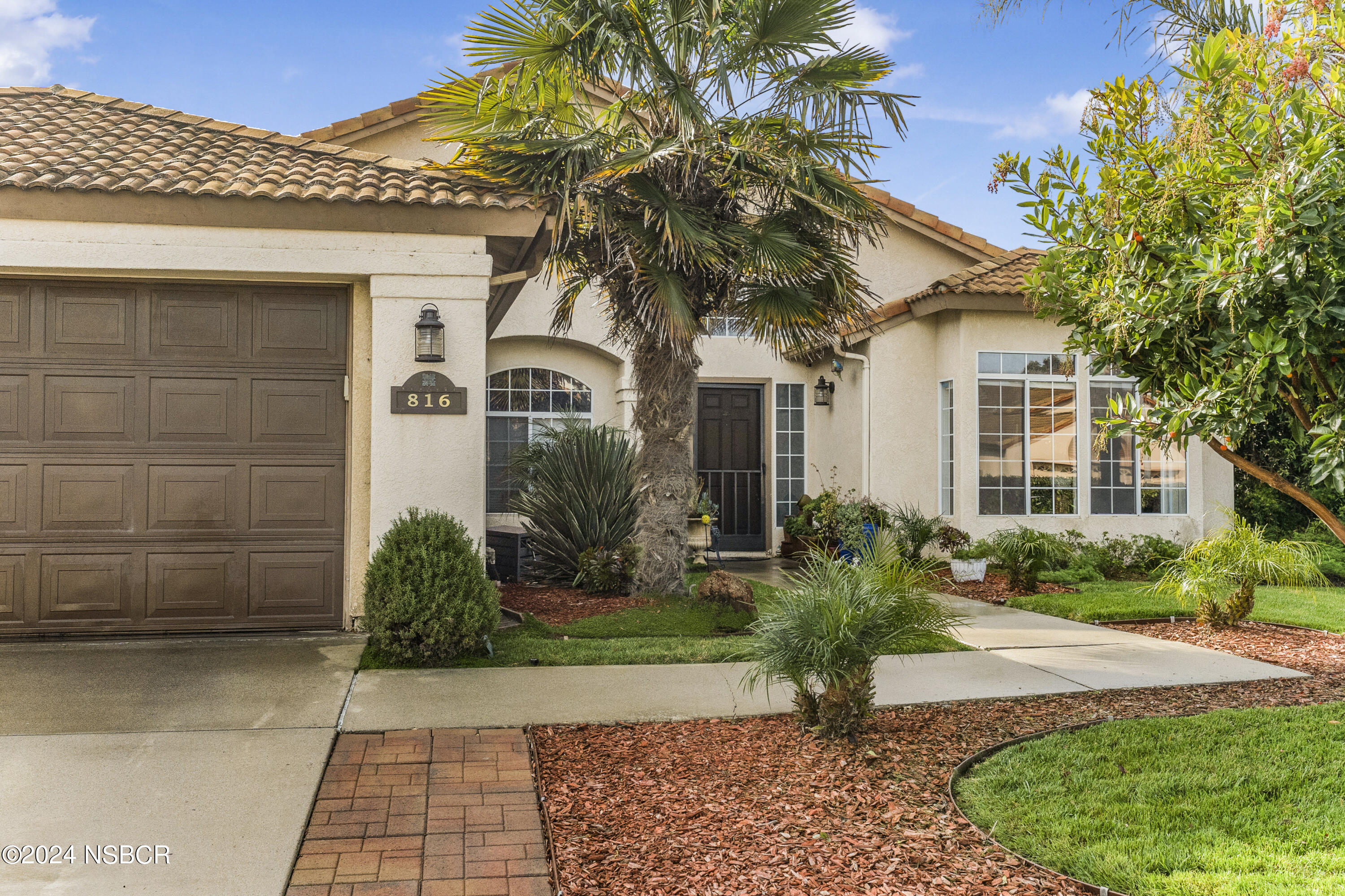 816 Cooper Drive Lompoc, CA 93436 - Photo 5 of 35 a front view of a house with a garden