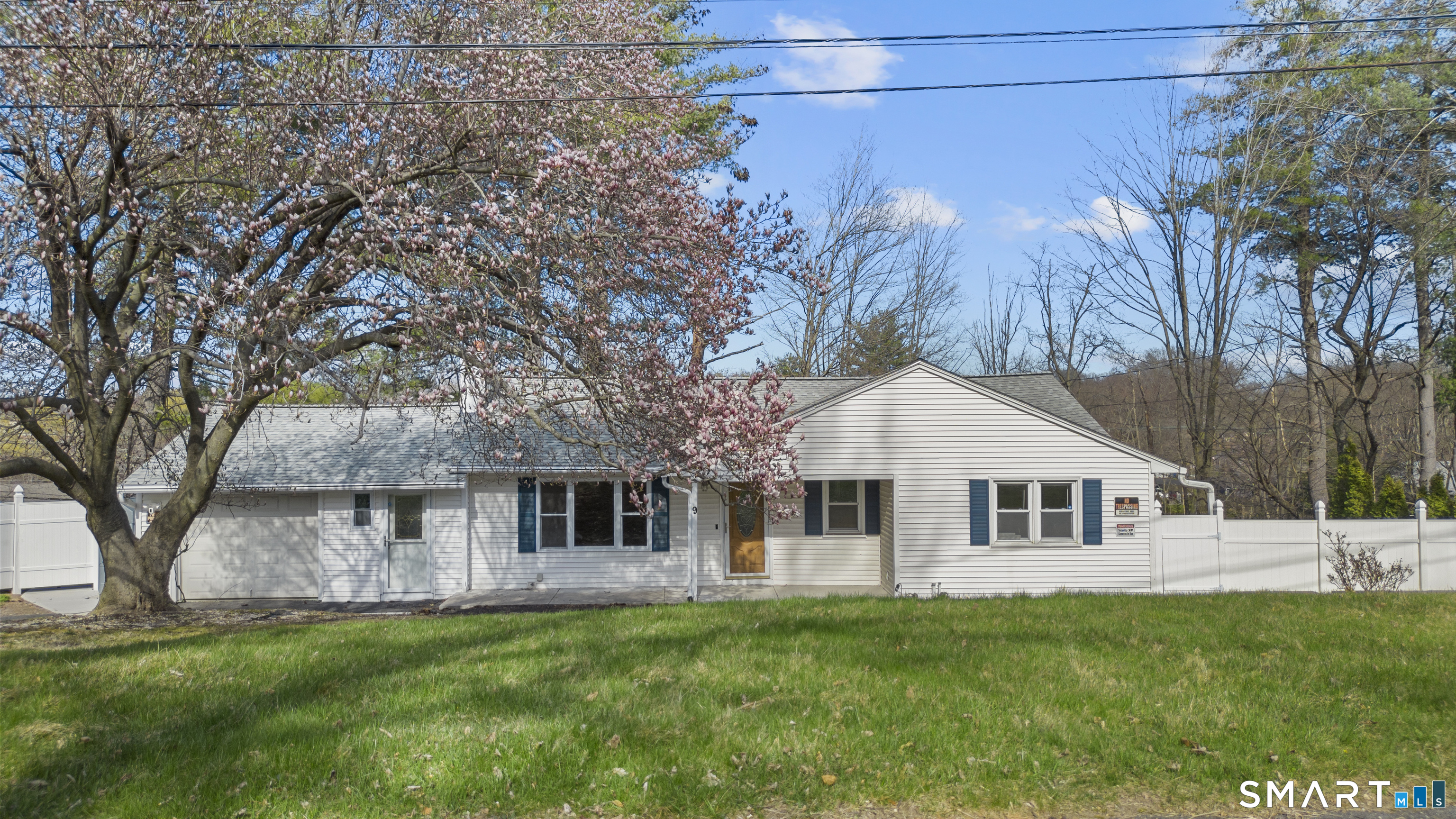 9 Daniel Road, Unit 9B Bristol, CT 06010 - Photo 1 of 16 a front view of a house with a garden and tree