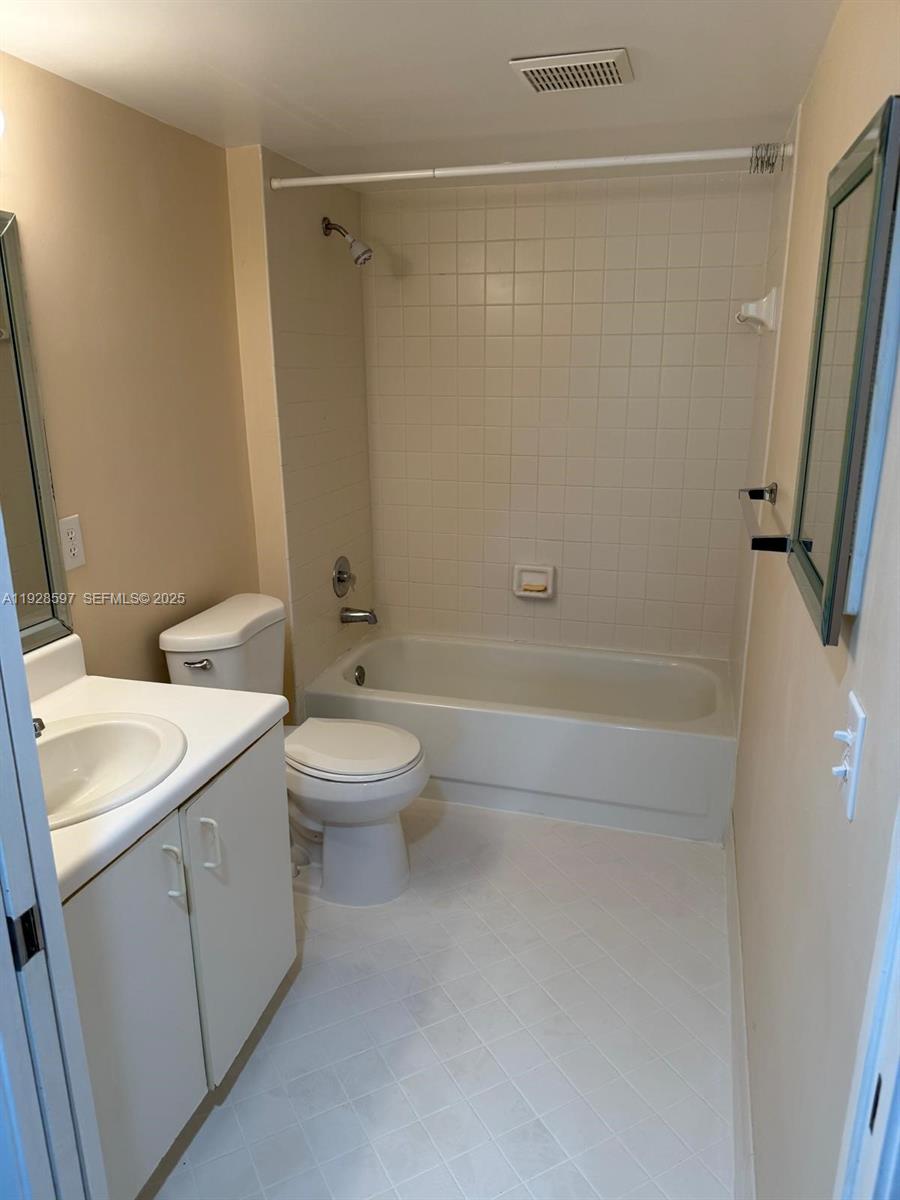 1201 Southwest 141st Avenue, Unit 304J Pembroke Pines, FL 33027 - Photo 14 of 31 a bathroom with a sink a toilet and shower