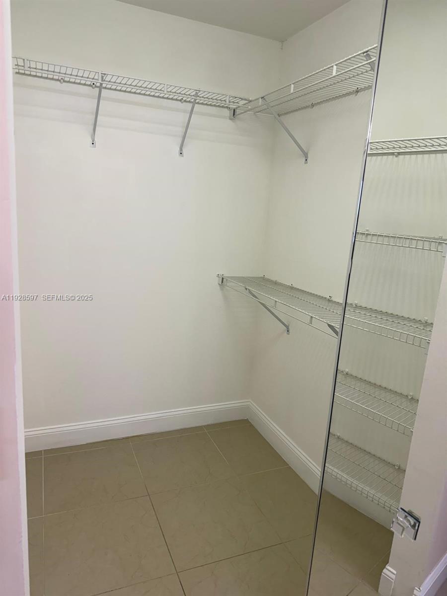 1201 Southwest 141st Avenue, Unit 304J Pembroke Pines, FL 33027 - Photo 15 of 31 a view of a room with racks on the wall