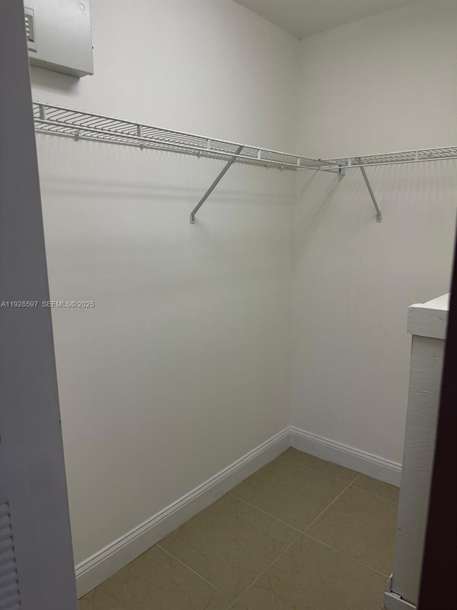 1201 Southwest 141st Avenue, Unit 304J Pembroke Pines, FL 33027 - Photo 16 of 31 a view of an empty walk in closet