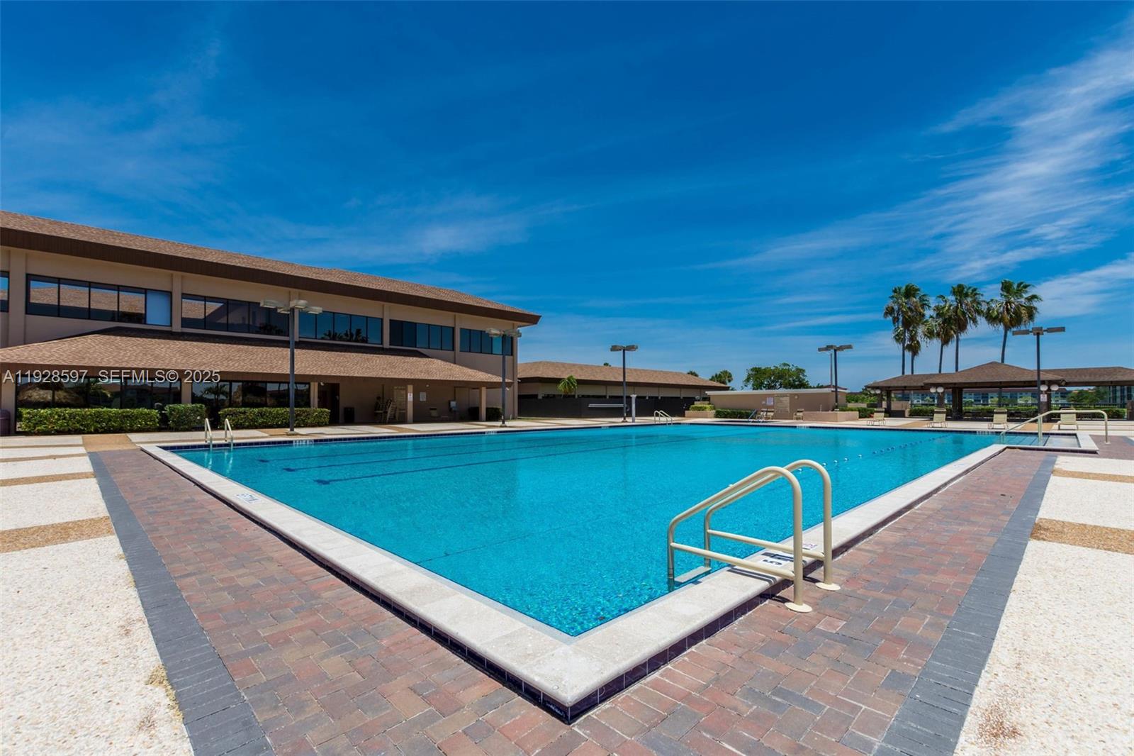 1201 Southwest 141st Avenue, Unit 304J Pembroke Pines, FL 33027 - Photo 27 of 31 a swimming pool with outdoor seating and yard