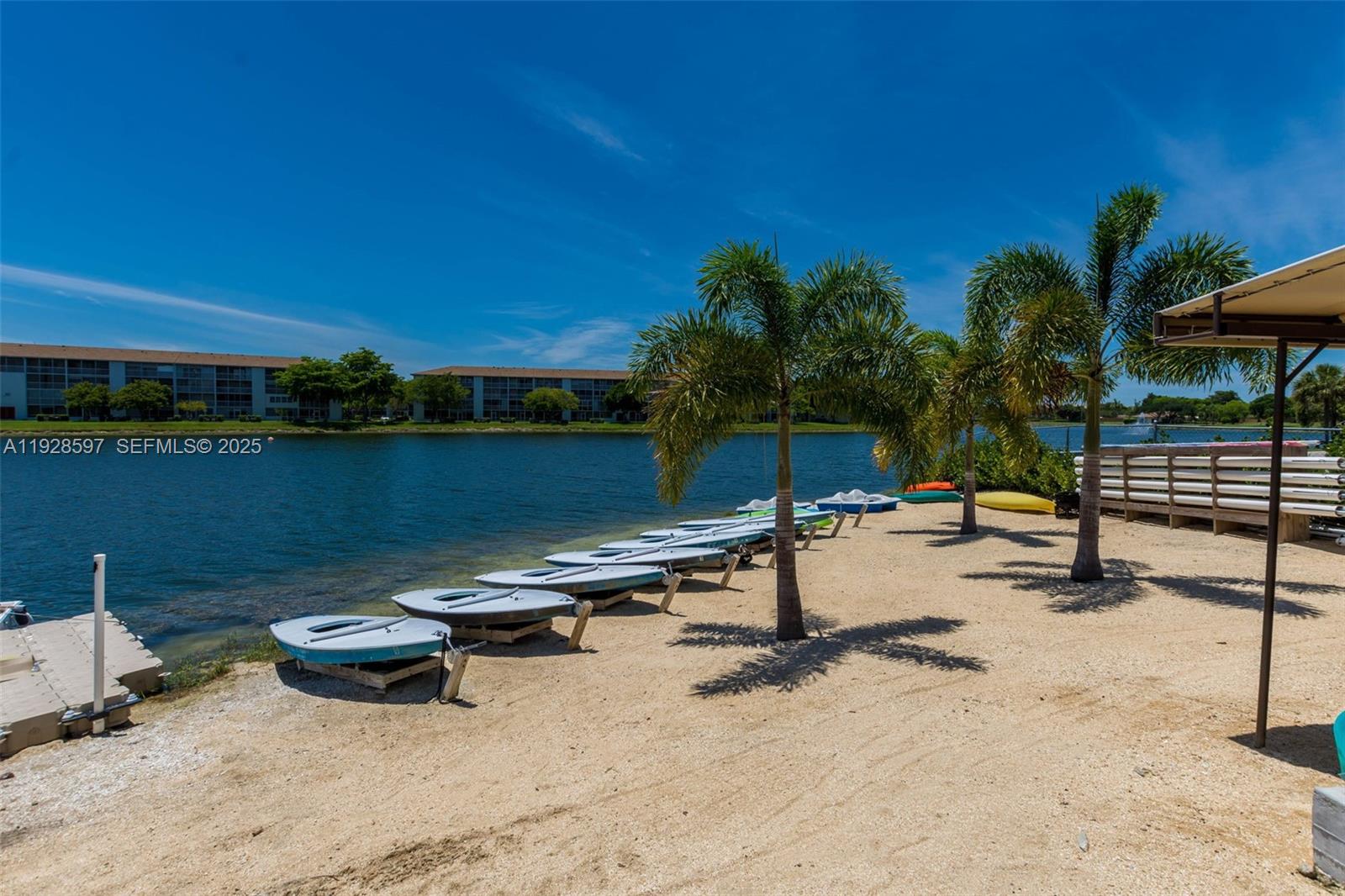 1201 Southwest 141st Avenue, Unit 304J Pembroke Pines, FL 33027 - Photo 30 of 31 a view of a lake with a sitting area